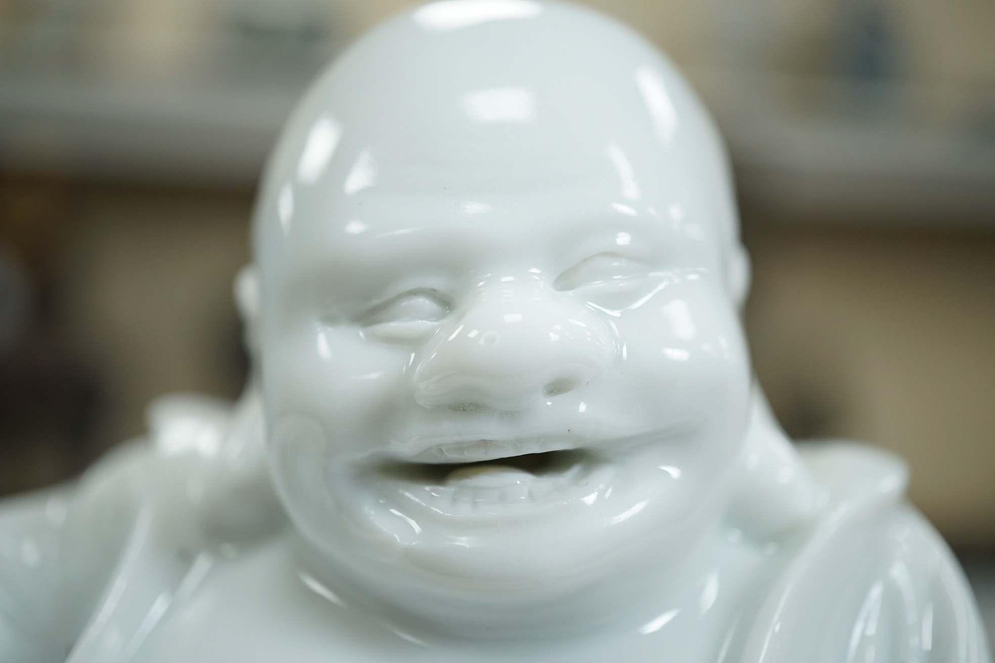 A Chinese blanc-de-chine seated figure of Budai, 18th/19th century